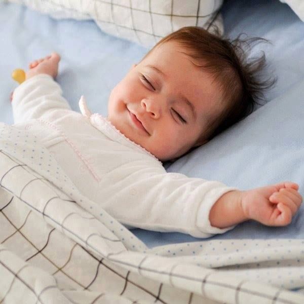 Mother gently caring for her baby using natural goat milk and Ayurvedic skincare products