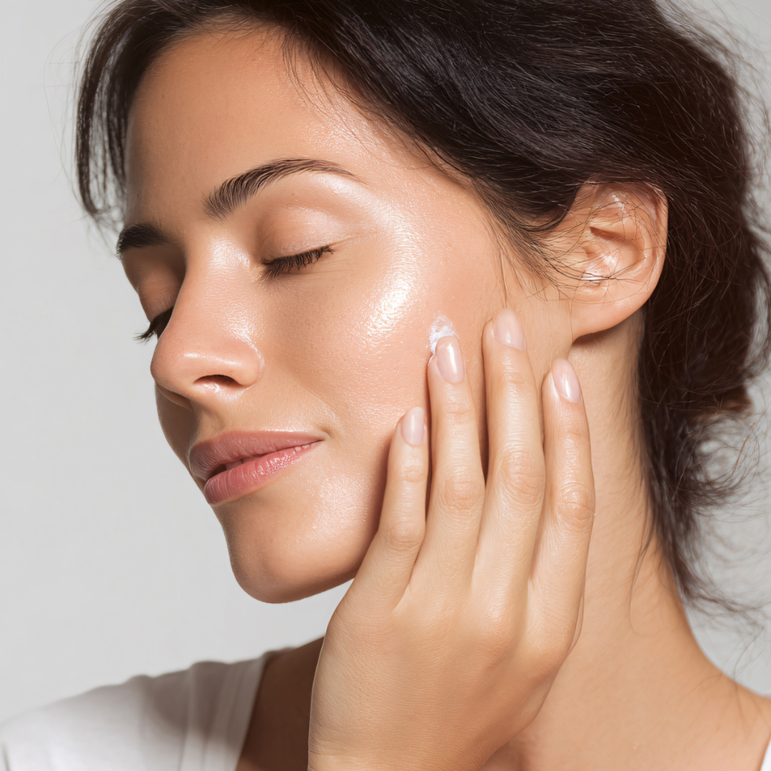 Woman with glowing, moisturized skin gently touching her face, representing nourishing Velora skin cream.